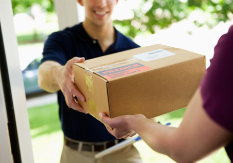 Phoenix Medical Courier driver handing a secured medical package to a healthcare provider at the door